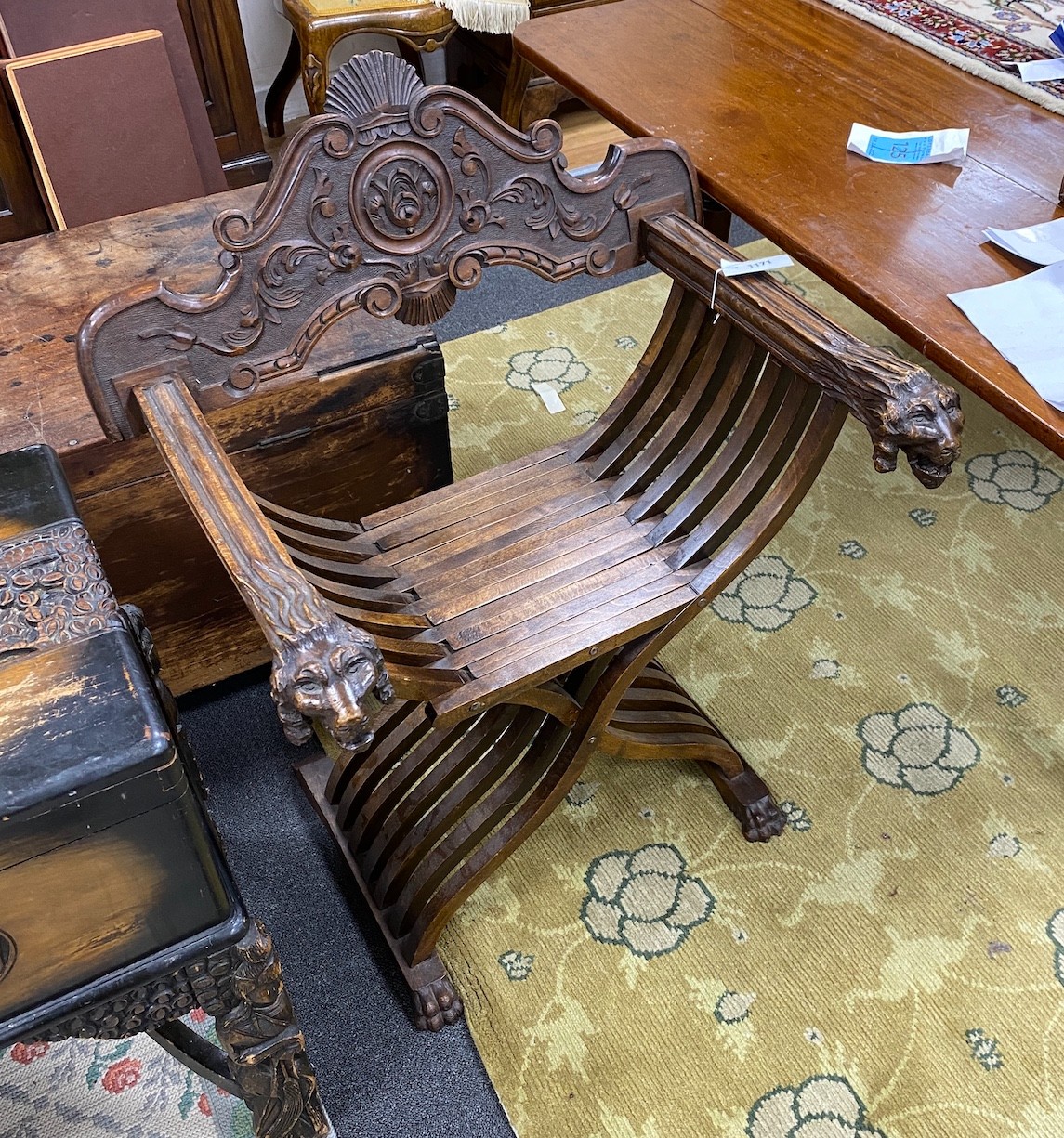 An Italian carved walnut folding Savaranola type elbow chair, width 66cm, depth 51cm, height 92cm